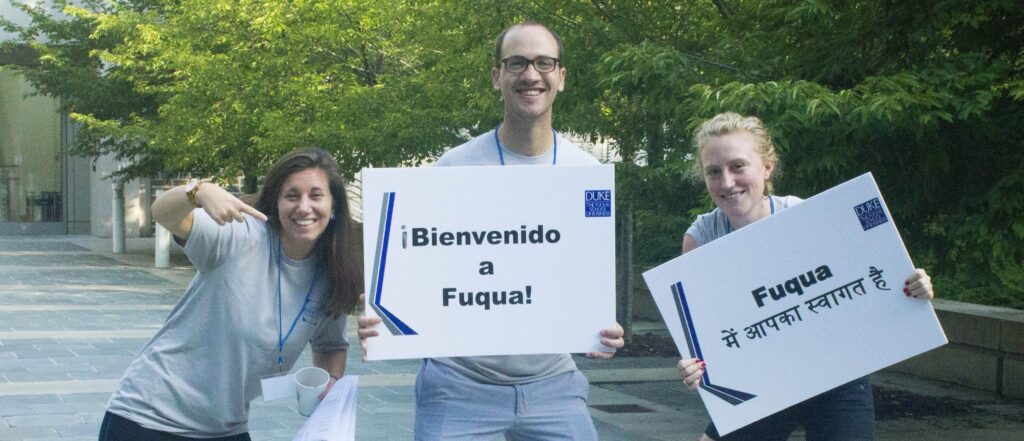 Students carrying Welcome signs to Fuqua