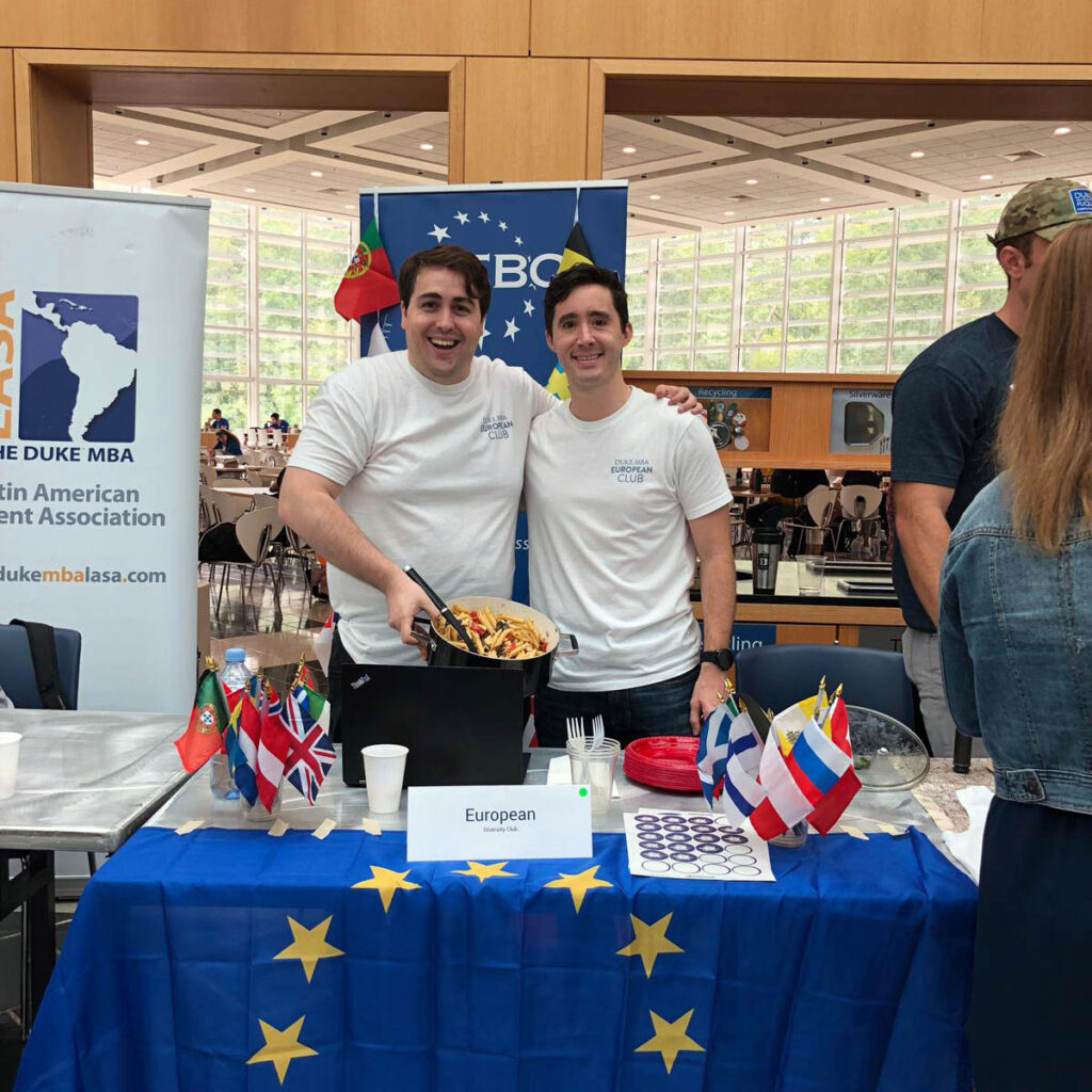 Adrien and a fellow European student at a booth welcoming international applicants to chat with them
