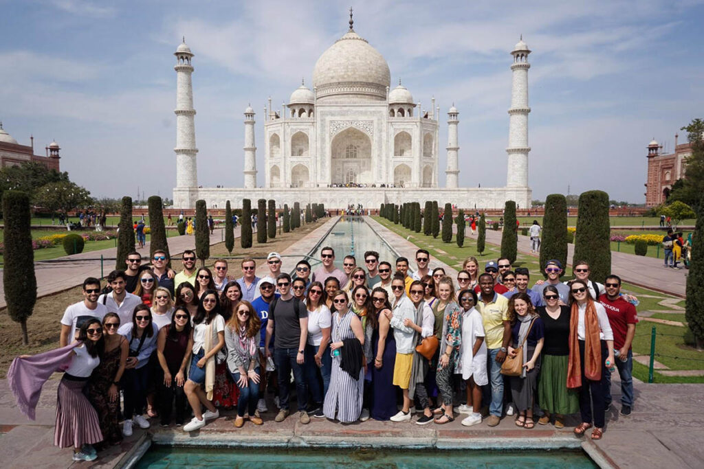 several dozen studetns posting in front of the Taj Mahal, one of Bishnu's most memorable experiences at Fuqua
