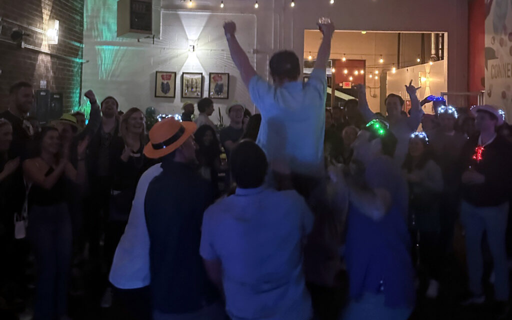 People dancing in a dark venue for Jewish Business Association's Bar Mitzvah party