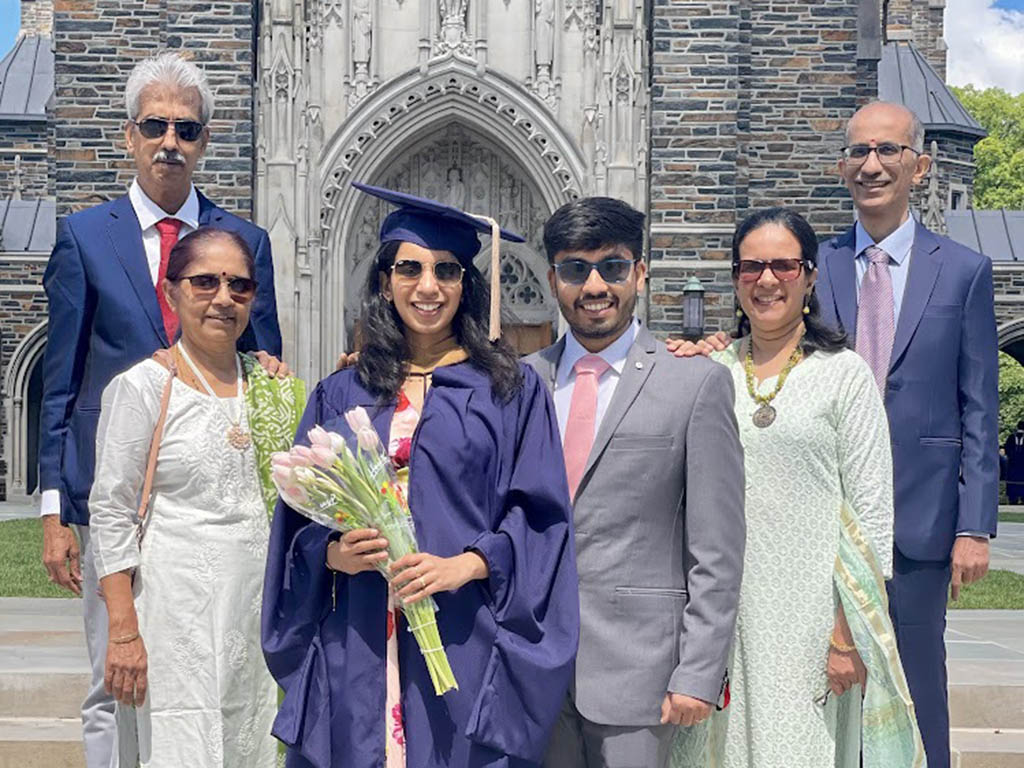 Padmini Muralidhar, husband and their parents in front of Duke Chapel on graduation day