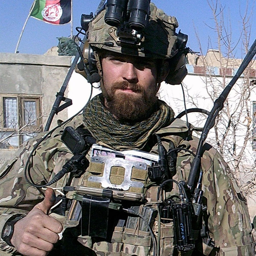 Nate Schwartzbauer in full Army uniform, doing a 'thumbs up' sign