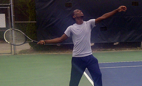 Student playing tennis