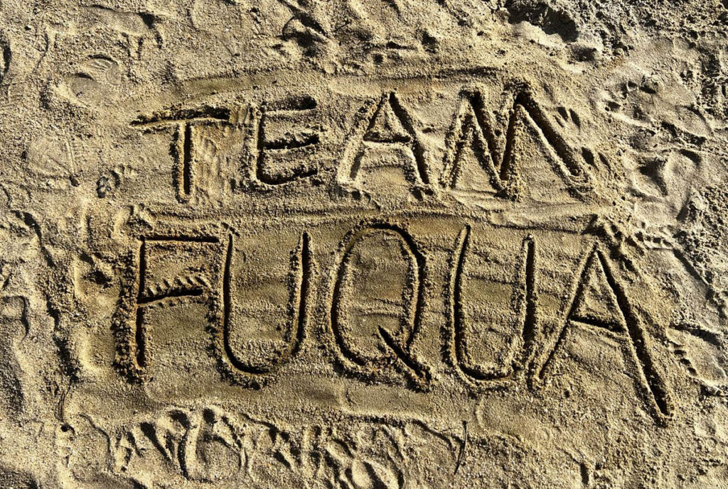 The words "Team" and  "Fuqua" spelled out in the sand; What Team Fuqua Means