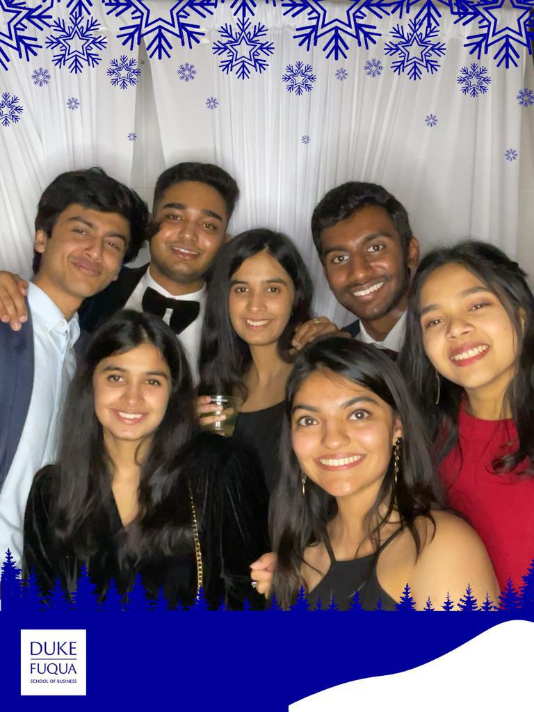 Anoushka and a handful of friends posing in a photo booth during formal