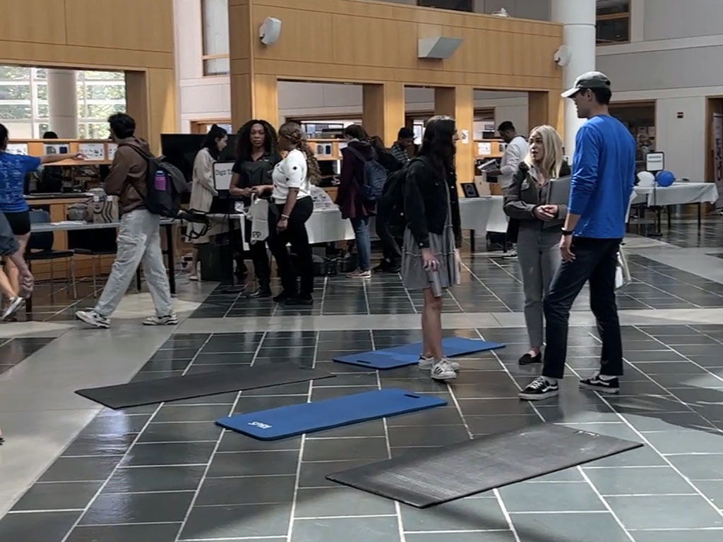 People scattered at booths across the Fox Center for the Fuqua Startup Marketplace at Duke University's Fuqua School of Business