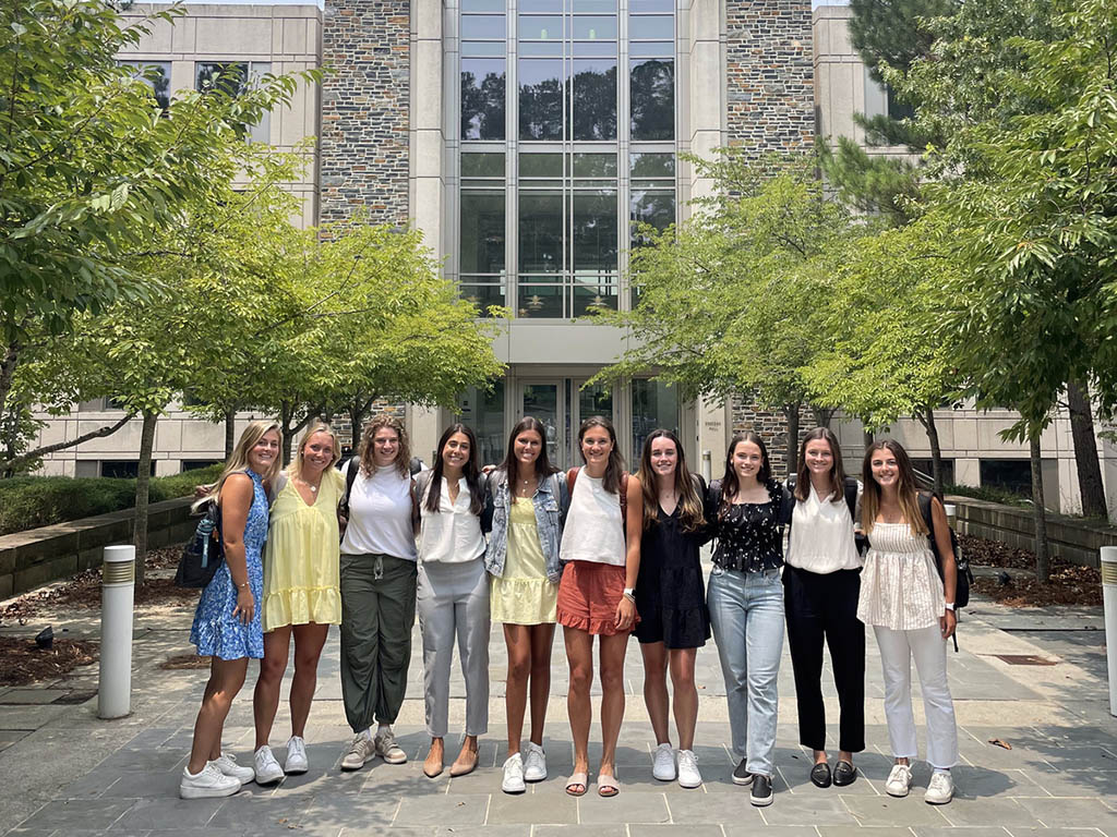 Caroline DeBellis, an MMS student at Duke University's Fuqua School of Business with fellow classmates outside of the School of Business