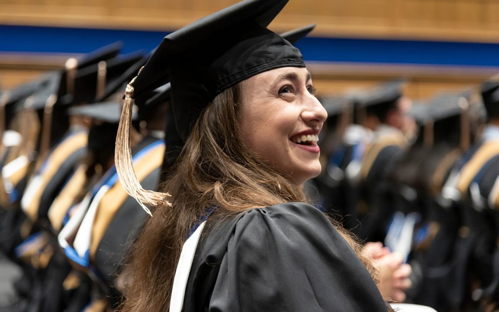 An MMS: FOB Class of 2023 graduate smiling during the commencement ceremony