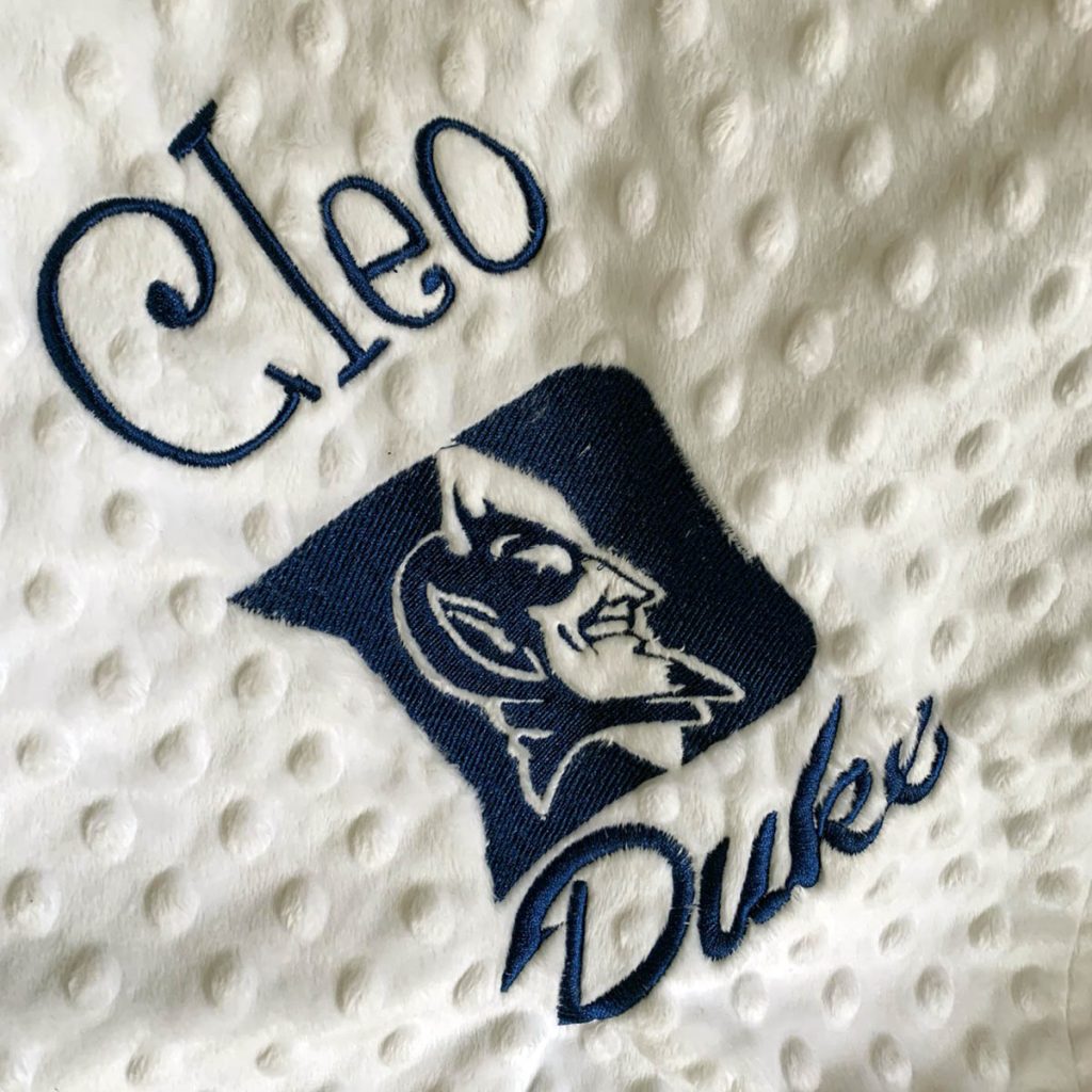 a blanket with Cleo's name sewn next to the Duke logo; work-life balance