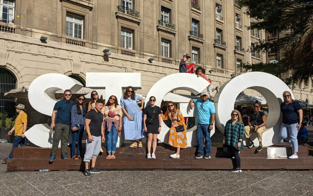 Sara Lavi with her Global Executive MBA classmates stand near a sign in Santiago, Chile