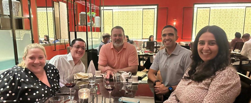 Rob Saylor with four of his classmates sitting around a table at a restaurant