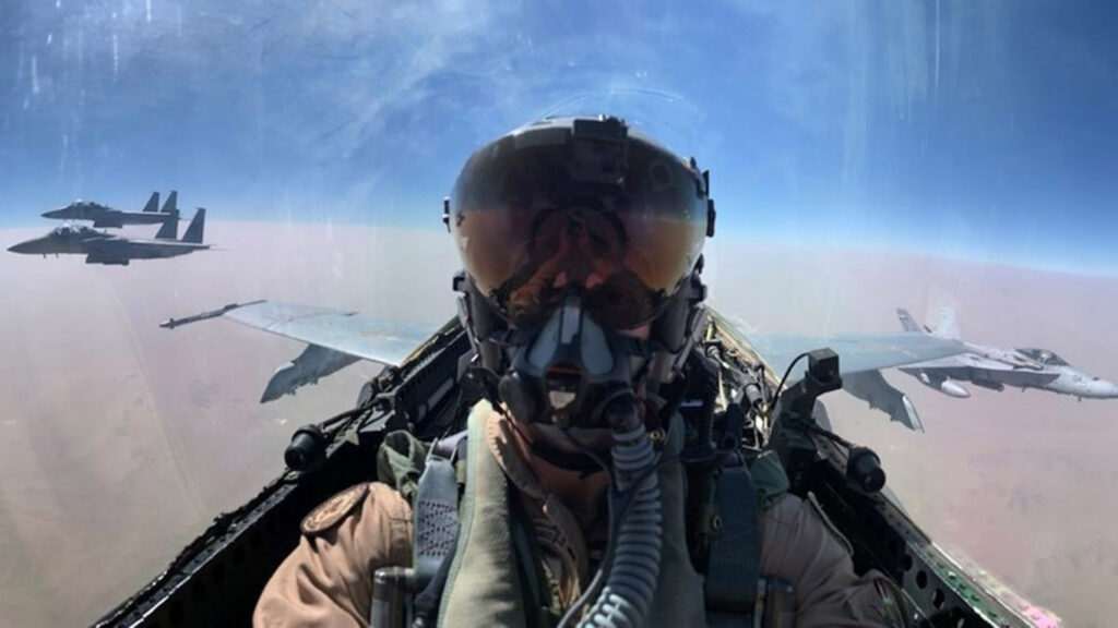 Tim Miller in cockpit, flighting FA/18, other planes can be seen on either side of Miller