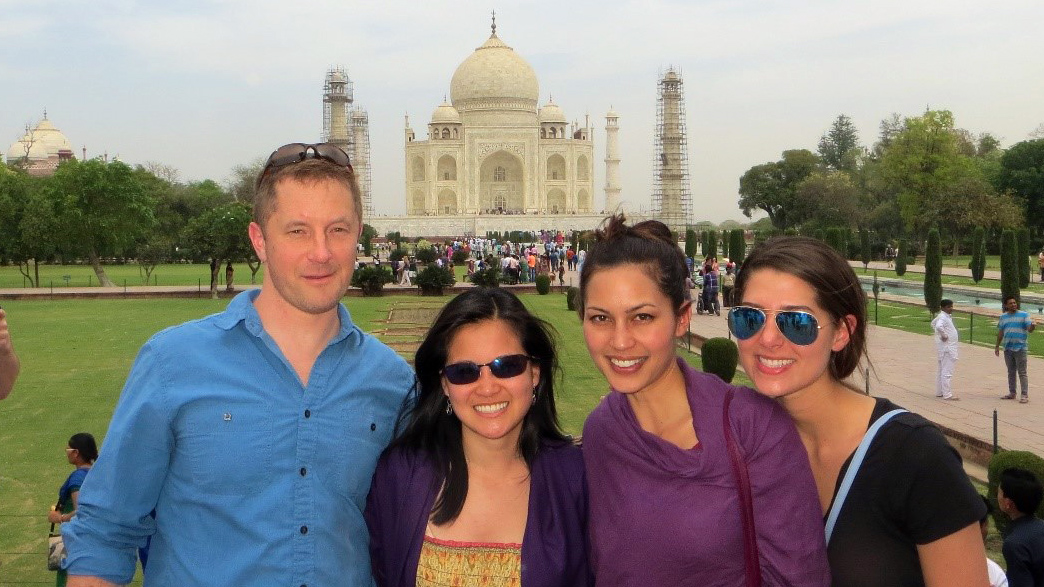 four classmates standing in front of the Taj Mahal provide a great representation of diversity at Fuqua
