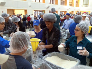 measuring rice for meals - the community at Duke Fuqua serves people in need through efforts like the annual Stop Hunger Now event