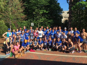 About 60 Fuqua students pose for a group photo, staying fit