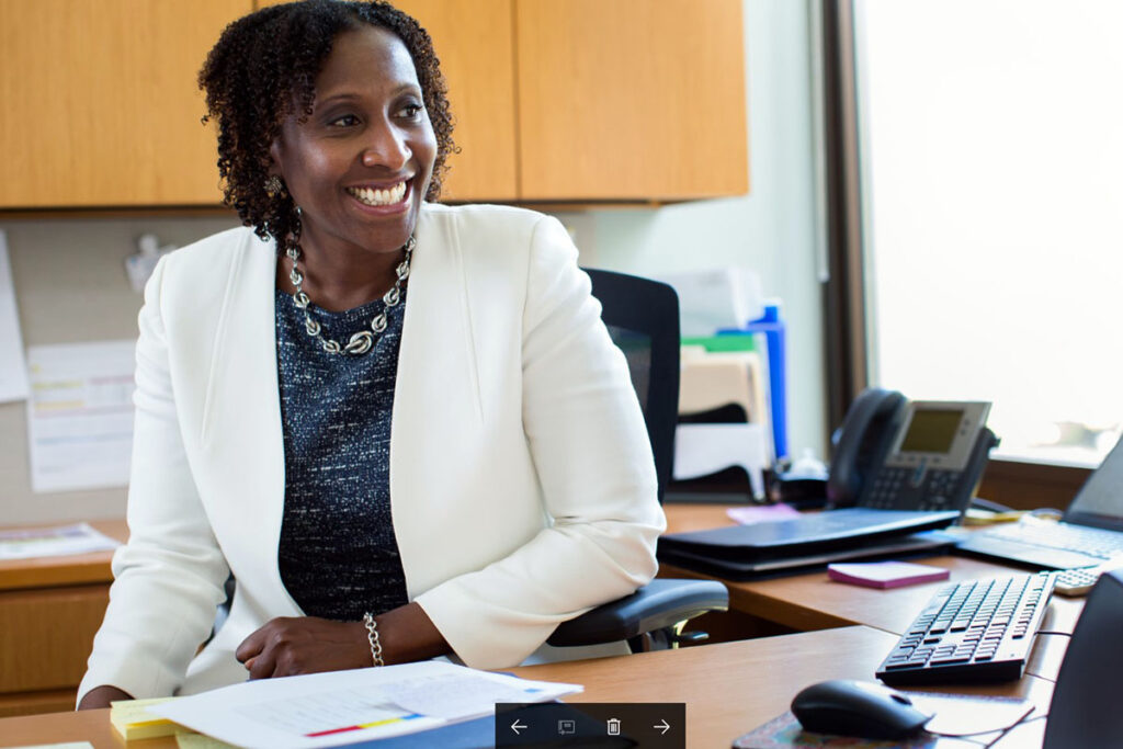 Shari Hubert sitting behind the desk in her admissions office, she believes in doing business better