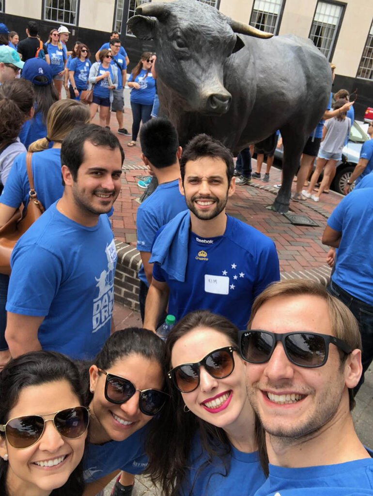 Students posing for a selfie with the bull statue in downtown Durham; one of the sites to see when exploring Durham