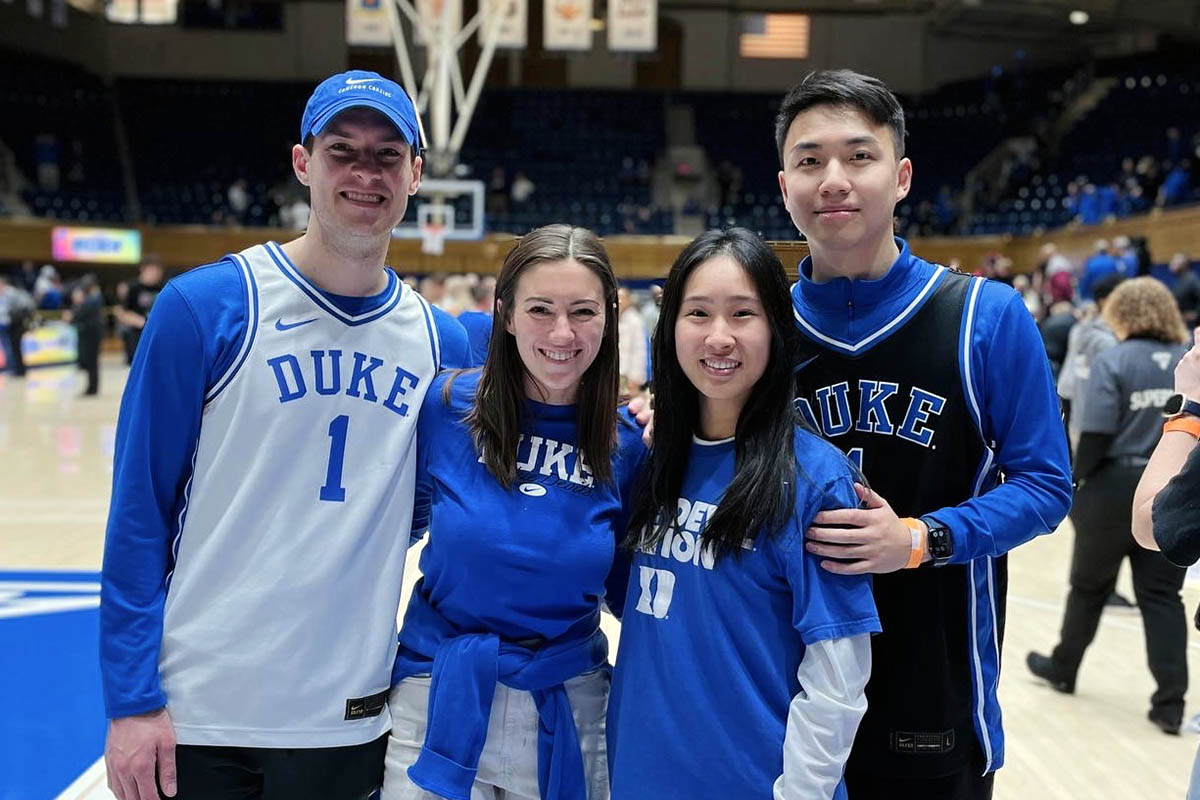 the four students and partners on Coach K court