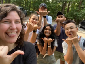 Zelda Hart and her five of her classmates holding up Blue Devil signs