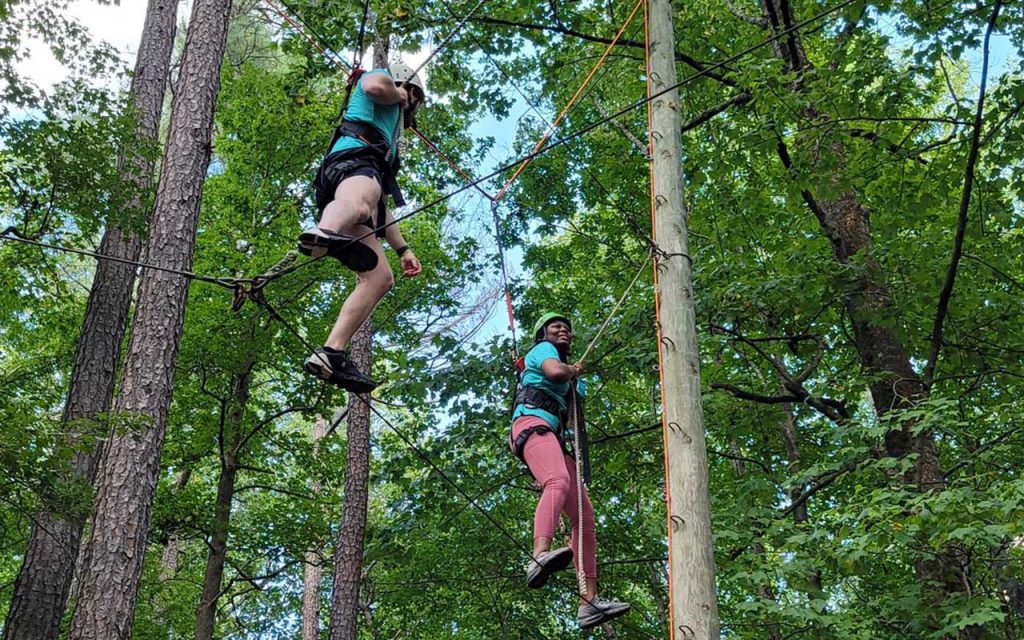 Taking on the high ropes course at Triangle Training Center during orientation. 