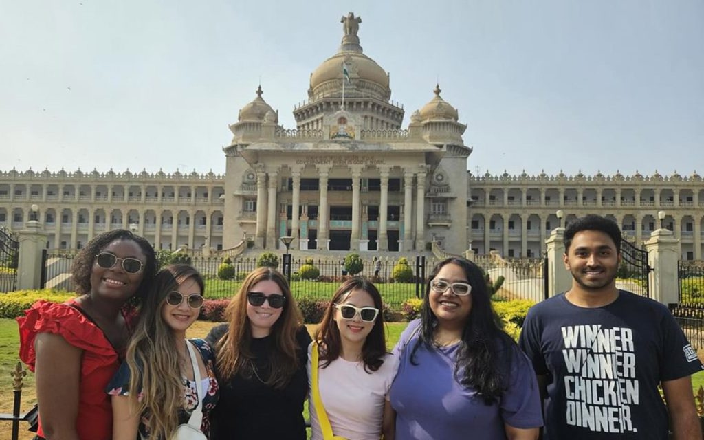 Traveling with a few of my MBA classmates, taking photos in front of a historic landmark. 