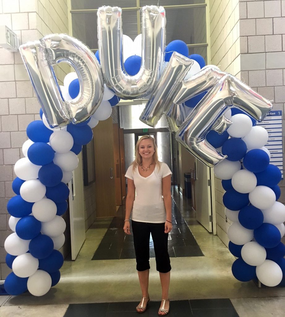 Ashley standing under a Duke banner at orientation after being admitted from the waitlist