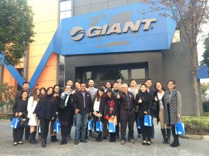 students and staff standing outside Giant offices, part of the program experience in China