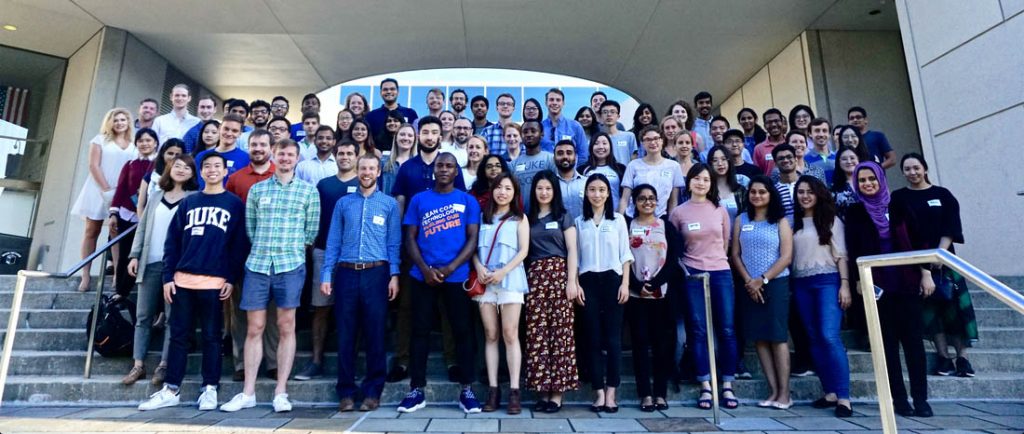 More than 50 Duke Interdisciplinary Social Innovators students pose for a group photo on the steps outside Fuqua