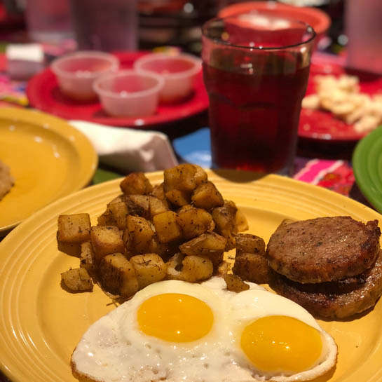 eggs sunny side up, sausage and home fries at Flying Biscuit, one of Lily's brunch recommendations