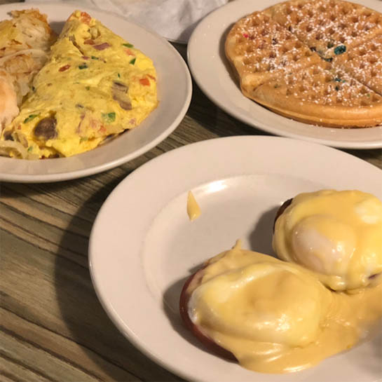 an omelet, waffle and eggs Benedict from Ye Olde Waffle Shoppe, one of Lily's brunch recommendations