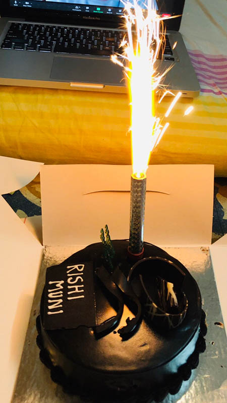 A chocolate birthday cake with a sparkler on top; MMS Bond