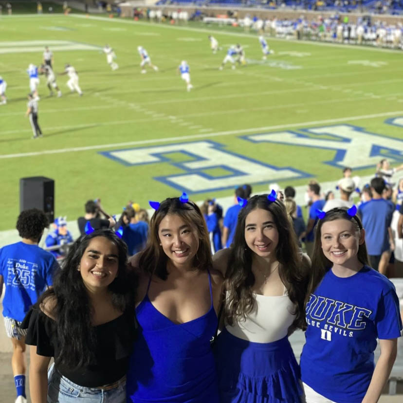 international student Renna and three friends at a Duke Football game
