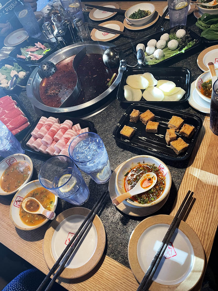 a table full of hotpot ingredients and cookware