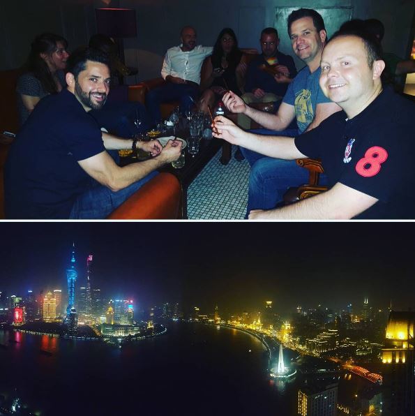 classmates toasting and a nighttime view of the river in Shanghai, during a day in the life of a Global Executive MBA student