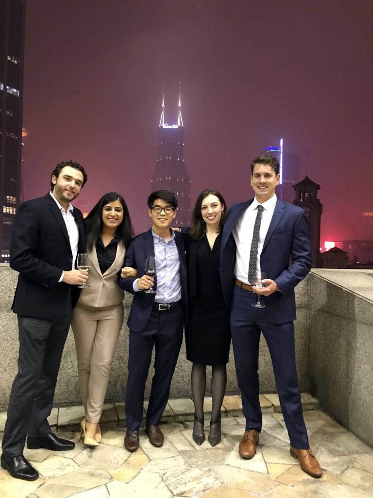 five students pose for a rooftop photo with Shanghai's skyline in the background; key learnings