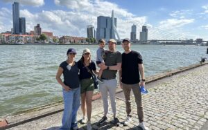 Ellie Amirnasr, a student in the Global Executive MBA program at Duke University's Fuqua School of Business, and her family in front of a river with a city skyline and bridge in the background