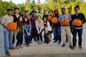 students displaying their freshly carved Halloween pumpkins, Fuqua is transforming me into a better person