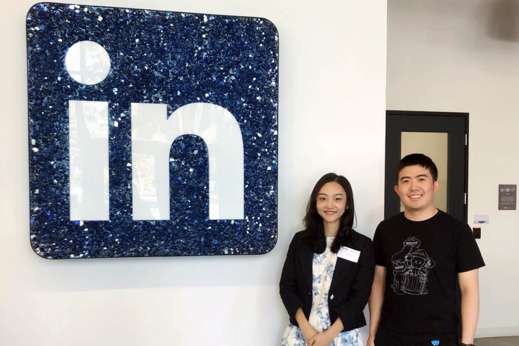 Rachel and a friend posing in front of the LinkedIn sign, exploring West Coast jobs