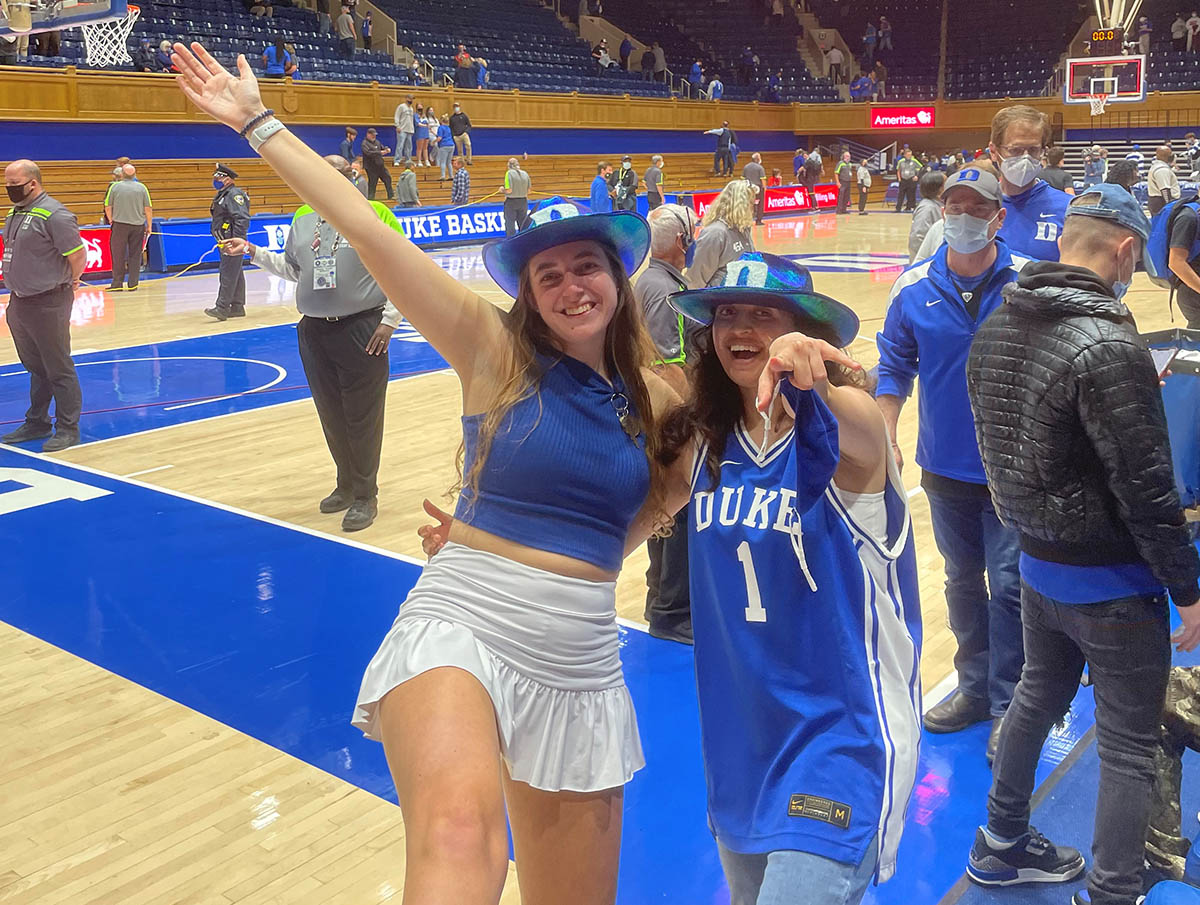 Two ladies at a Duke basketball game; MQM Finance Track