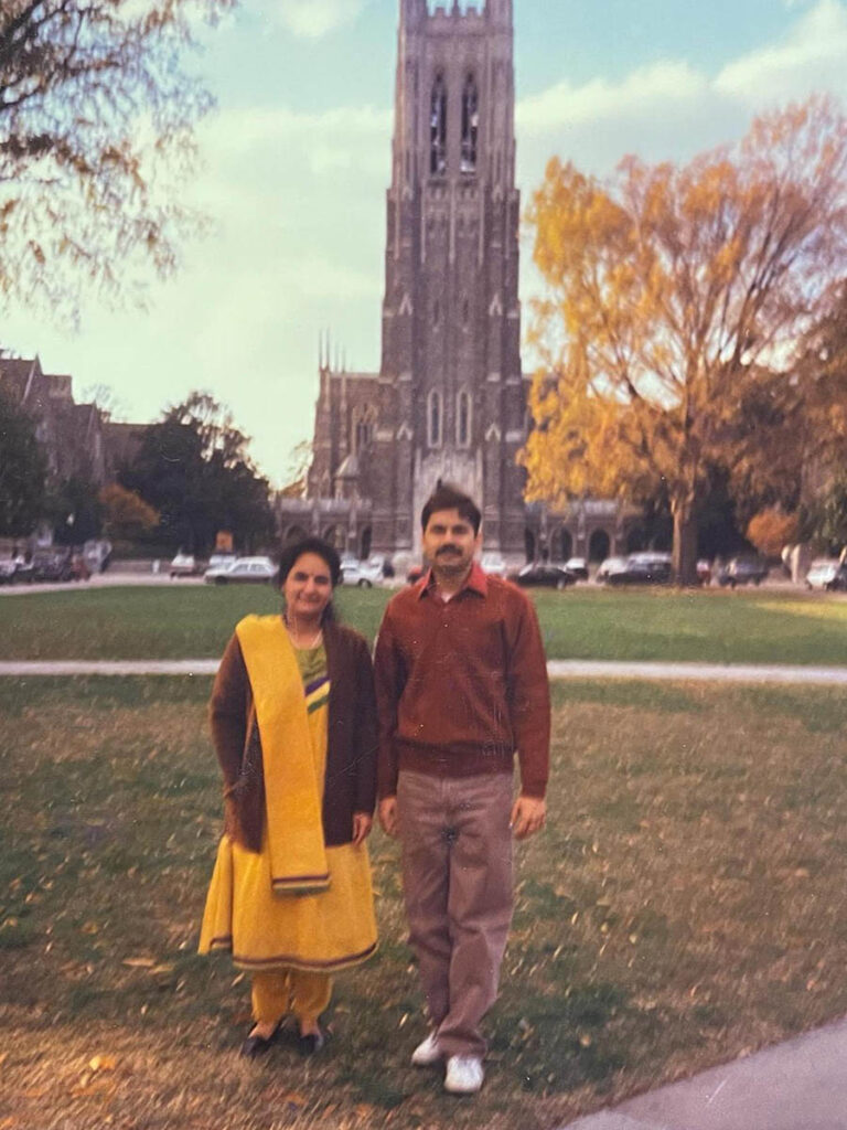 Vinaik's parents posing for a photo in front the chapel