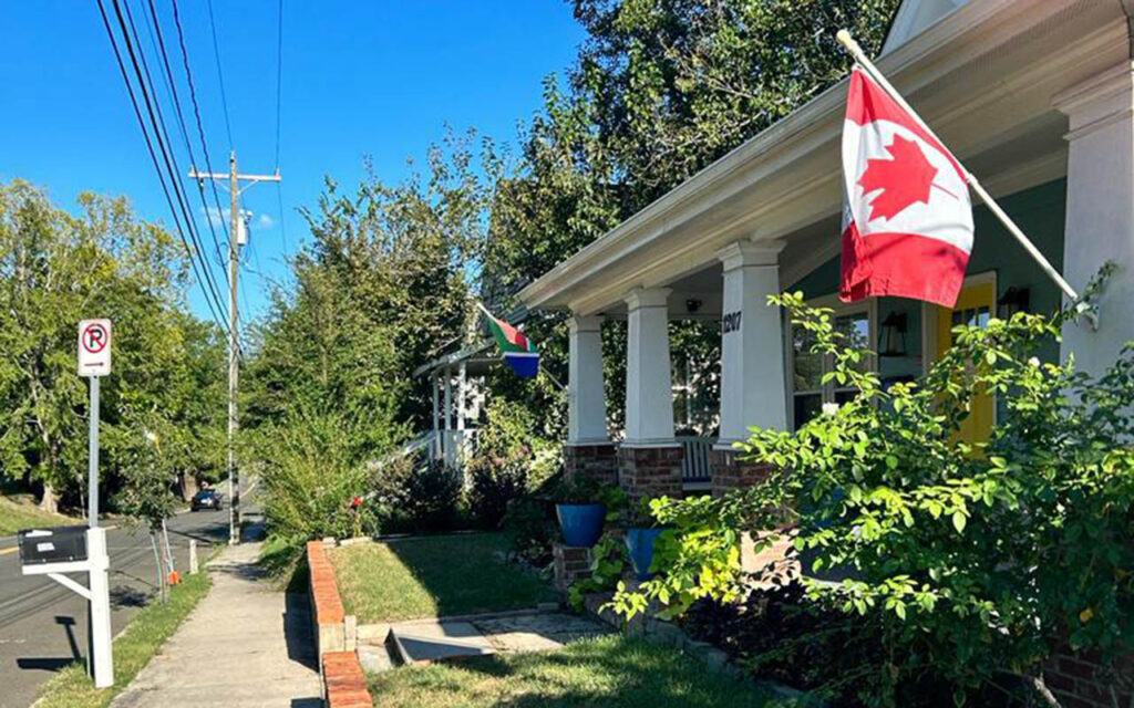 The front porch of a home displays the flags of Canada and South Africa