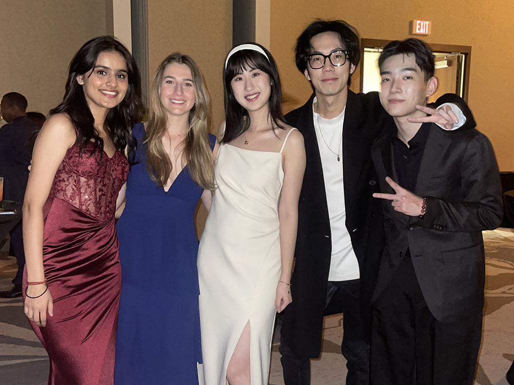 Caterina Mora and four of MQM classmates dressed in formal attire at an event hosted for students in the MQM program at Duke University's Fuqua School of Business