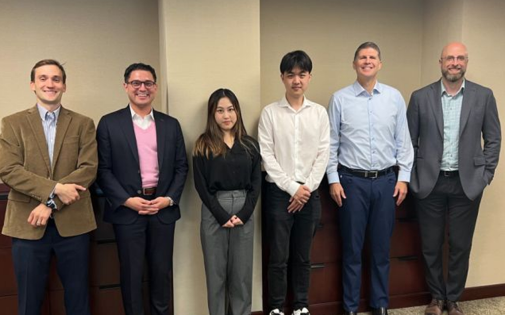 Nicholas Skerpon of the MSQM program with his experiential learning classmates and professors at Duke University's Fuqua School of Business