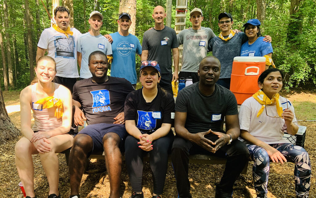 Weekend Executive MBA students pose for photo at high ropes course